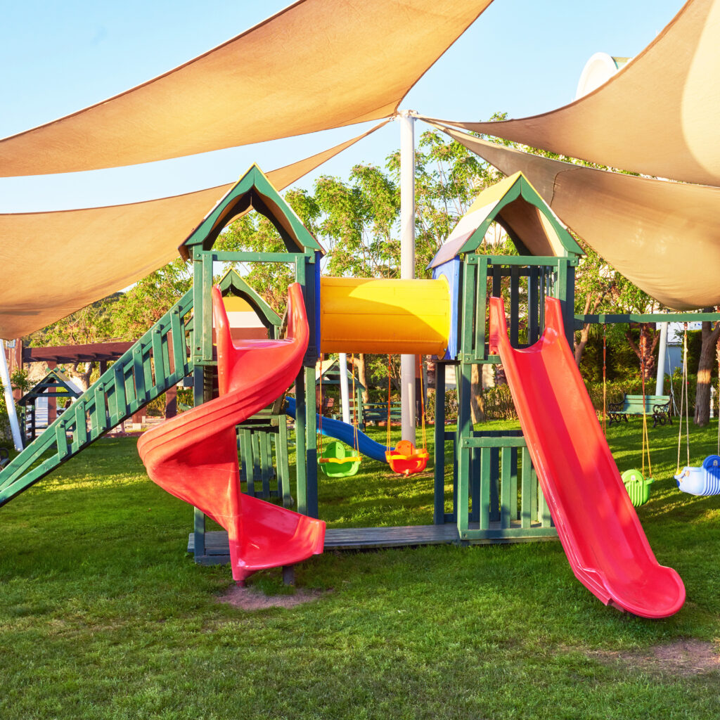 Colorful playground in the yard in the park at sunset